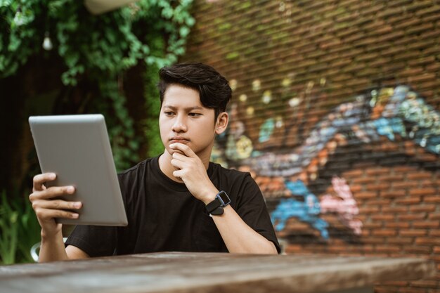 Serious young man using a tablet pc