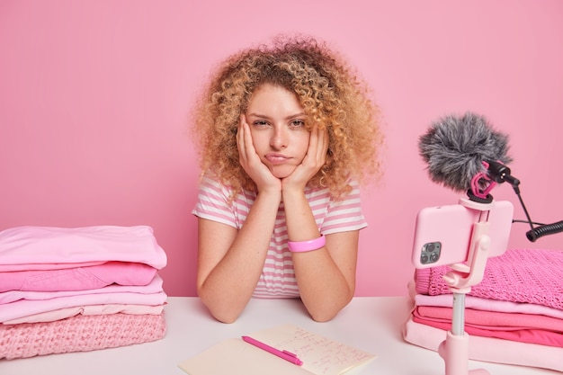 Serious young woman looks directly at camera