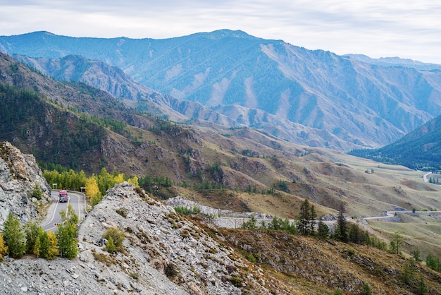 Serpentine mountain road View of the Chuysky tract from ChikeTaman pass Altai mountains Russia