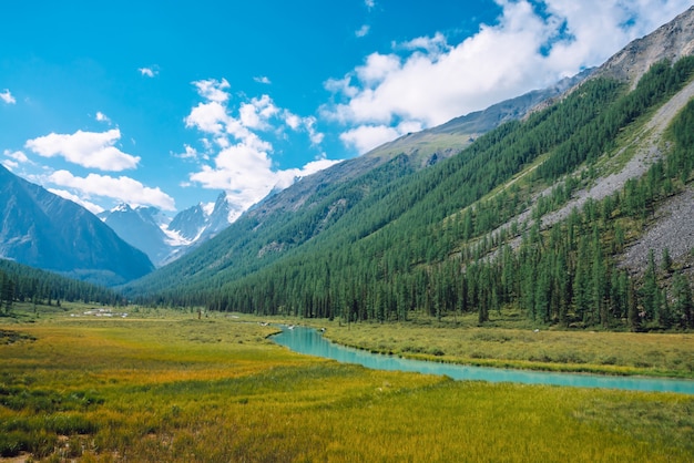 Serpentine river in valley before beautiful glacier. .