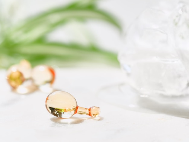 Serum capsules for healthy skin with palm leaf and ice balls