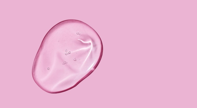 写真 ピンクの背景に血清ゲル見本化粧品透明ゲル血清テクスチャ