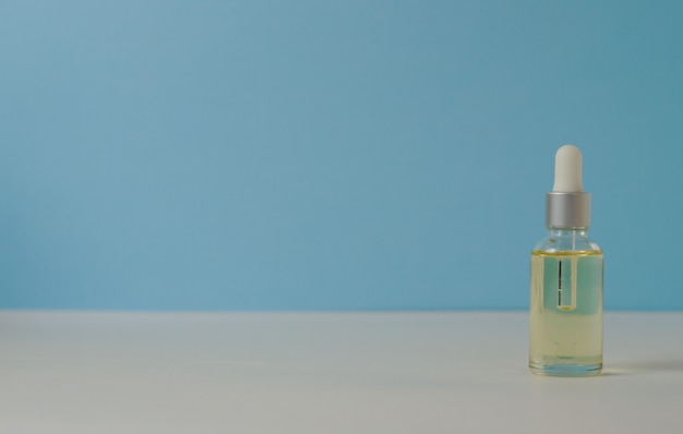 Serum in a glass bottle. Aromatherapy oil, natural cosmetics concept