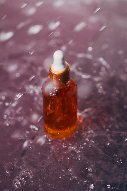 Serum in a glass bottle with a pipette oil for the care of womens skin