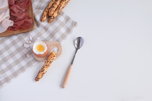 Served breakfast boiled egg in wooden egg cup