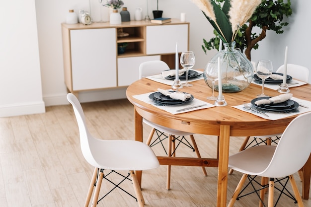 Served dining table in a modern Scandinavian kitchen.