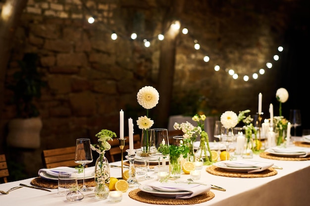 写真 ディナー テーブル プレート ナプキンワイングラス花とキャンドルを提供