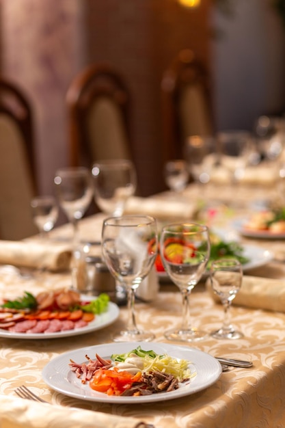 Served festive table with snacks glasses glasses cutlery and napkins for a banquet