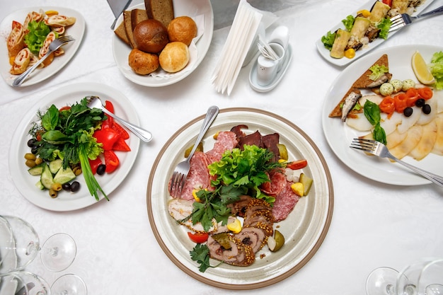 Served round banquet table with dishes.