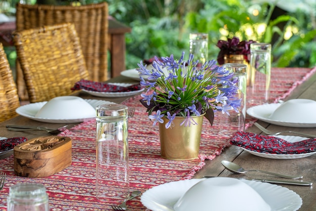 Served table and rattan chairs in an empty restaurant terrace. Tanzania, east Africa