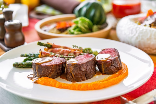 Served table in a restaurant with meat dishes. Different dishes