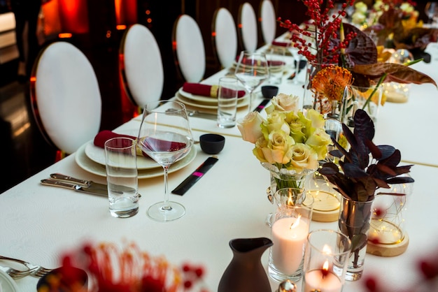 Served table with fabric napkins and decorated with floral deco