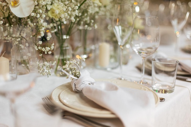 Served wedding table with decorative fresh white flowers and candles