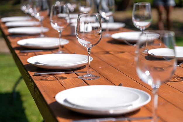 Served wooden table without a tablecloth. Cafe in the open air park