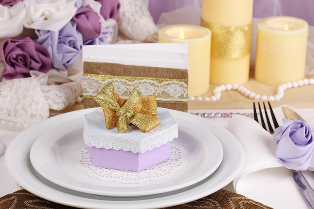 Serveert fantastische bruiloftstafel in paarse en gouden kleur op witte en paarse stoffenachtergrond