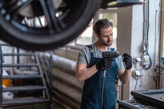 Service man aan het werk in de autoreparatiewerkplaats