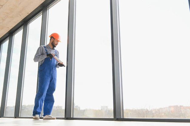 Service man installing plastic window