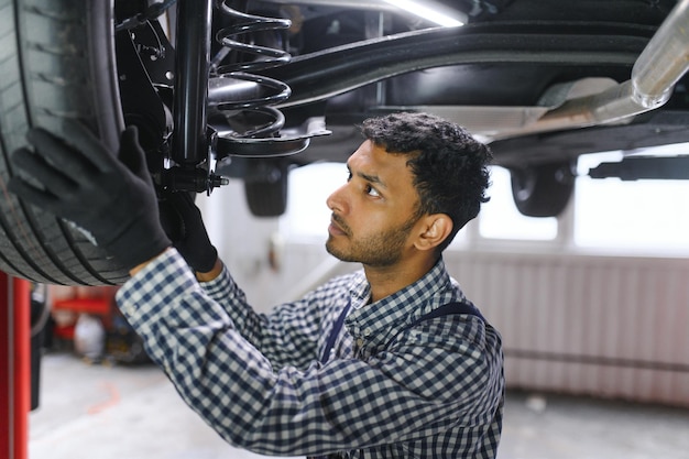 Service repair and profession concept indian mechanic at car service
