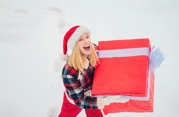 Service women with big gift box santa woman holds a big gift box with copy space for your text happy