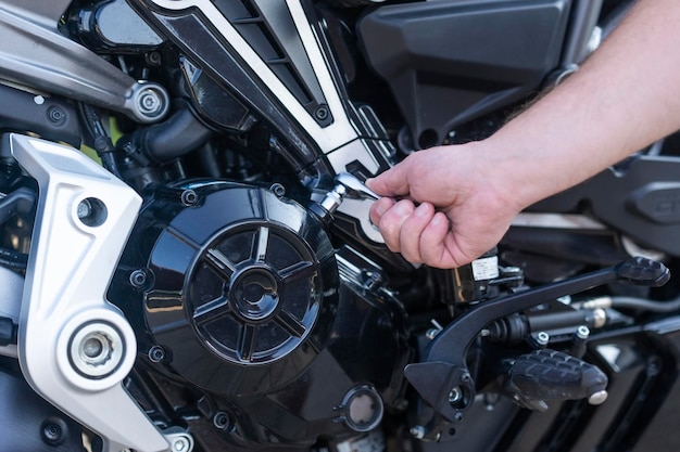 A service worker repairing a motorcycle at the service center