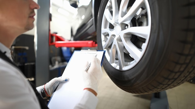 Serviceman inspects a presale vehicle against