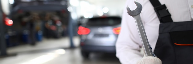 Serviceman in white protective gloves hold matall key