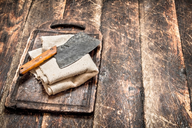 Serving background. Old hatchet on a chopping Board.