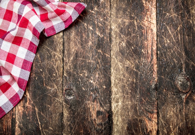 Serving background. Textile napkin. On a wooden table.