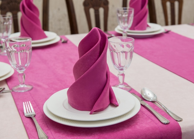 Serving banquet table in a luxurious restaurant in pink and white style