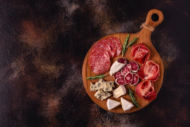 Serving board with meat and cheese snacks