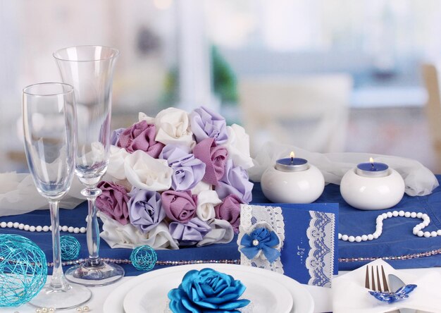 Serving fabulous wedding table in purple and blue color of the restaurant background