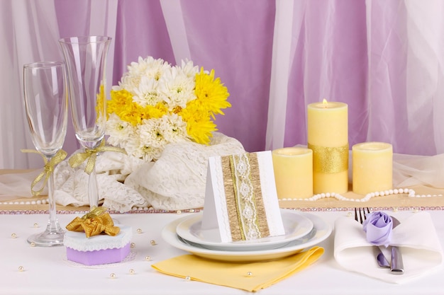 Serving fabulous wedding table in purple and yellow color on white and purple fabric background