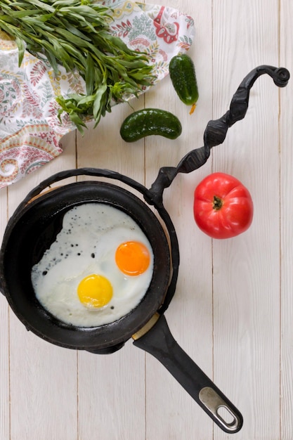 Serving scrambled eggs for breakfast in a beautiful frying pan