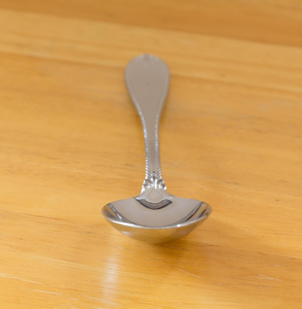 Serving spoon stainless steel on wood