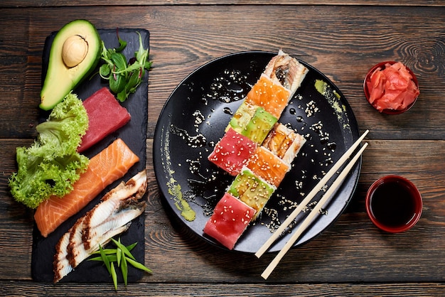 Serving sushi rolls and other traditional japanese and asian\
food on a table