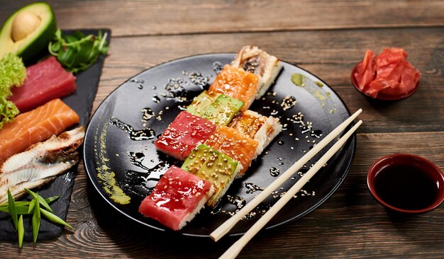 Serving sushi rolls and other traditional japanese and asian food on a table