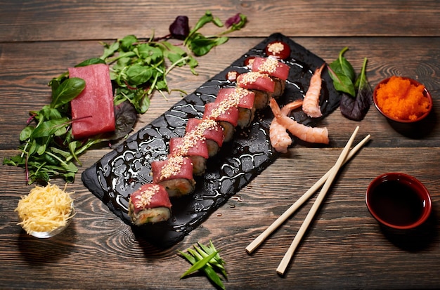 Serving sushi rolls and other traditional japanese and asian
food on a table