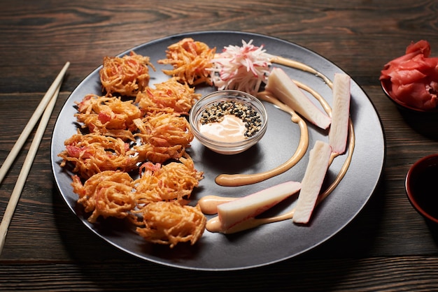 Serving sushi rolls and other traditional japanese and asian food on a table