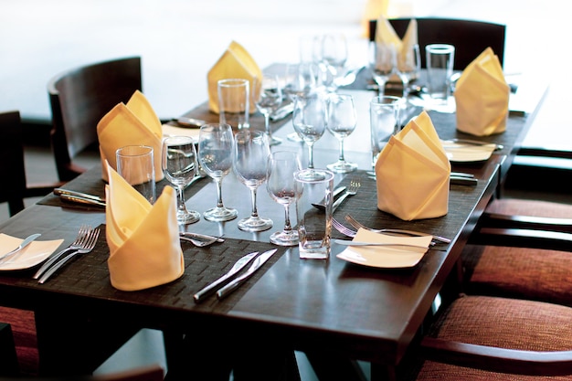 Serving table in restaurant with wine glasses and cutlery Table served 