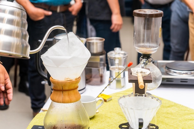 Serving water to prepare excellent coffee during a cupping event