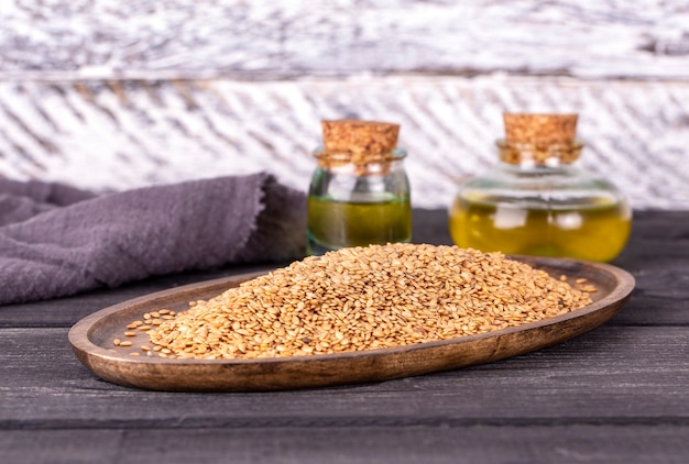 Sesame oil in glass and seeds