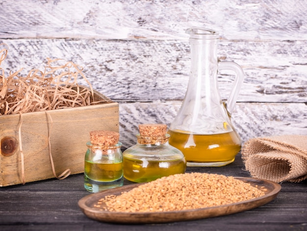 Sesame oil in glass and seeds