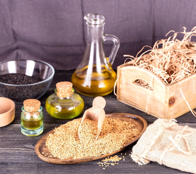 Sesame oil in glass and seeds