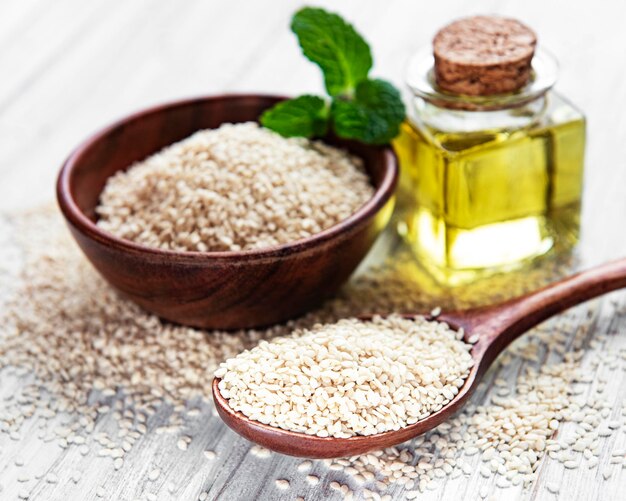 Sesame oil and seeds on a rustic table