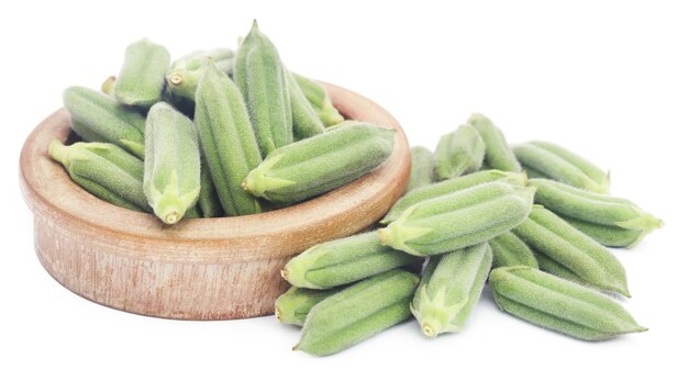 Sesame pods in a bowl over white background