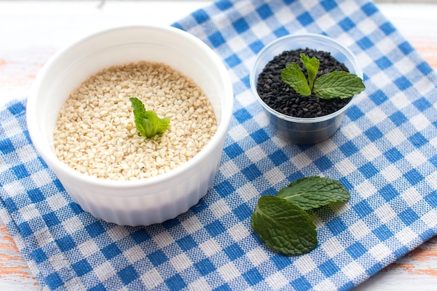 sesame seeds in a bowl on a wooden background Seasoning for cooking