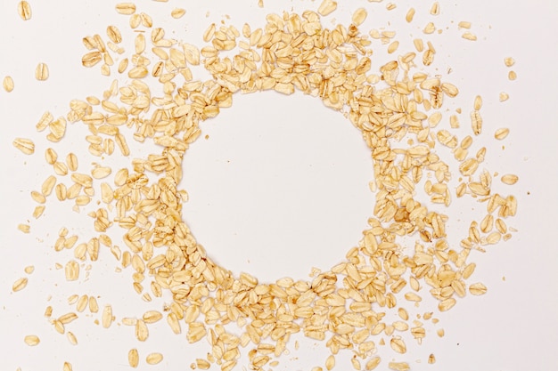 Sesame seeds in a circle on white background