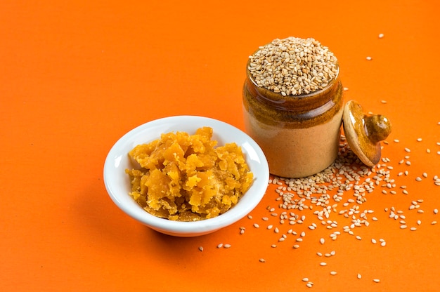 Sesame Seeds in clay pot with Jaggery in bowl