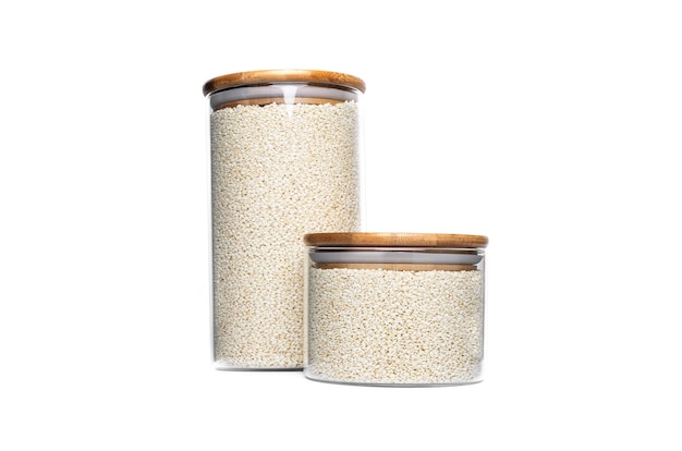 Sesame seeds in glass jar isolated.