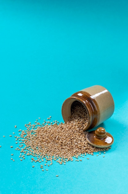 Sesame Seeds in pot on blue background